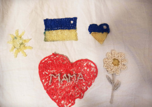 Na zdjęciu piec rzeczy wykonanych długopisem 3 D. Żółte słońce, flaga Ukrainy, niebiesko żółte serce, biały kwiat i serce z napisem Mama.